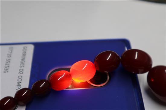 A simulated cherry amber necklace, two amber set brooches, a pair of earrings and a bracelet section?